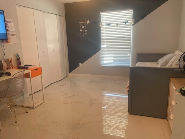 5848 Milton Ave, Sarasota, FL 34243 - bedroom with marble look tiles, a closet, and an office area