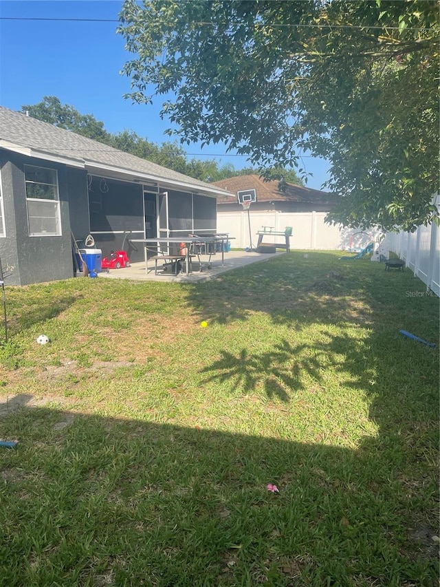 5848 Milton Ave, Sarasota, FL 34243 - fenced backyard with a sunroom