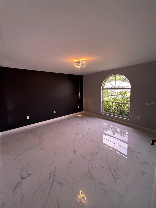 5848 Milton Ave, Sarasota, FL 34243 - unfurnished room featuring light marble finish floors and baseboards