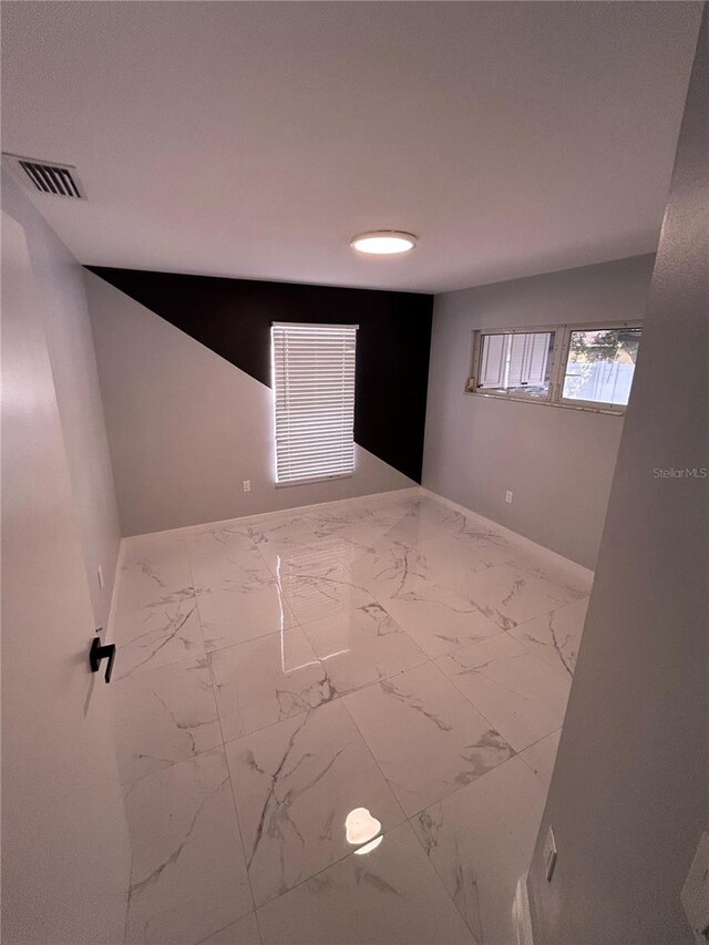 5848 Milton Ave, Sarasota, FL 34243 - empty room with marble finish flooring