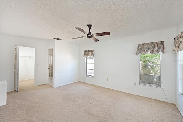 6406 16th Avenue Dr W, Bradenton, FL 34209 - empty room with light colored carpet, a ceiling fan, and a textured ceiling