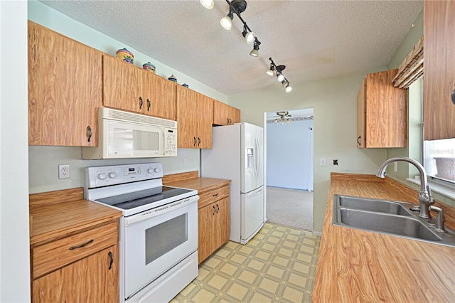 6406 16th Avenue Dr W, Bradenton, FL 34209 - kitchen with white appliances, a textured ceiling, track lighting, light countertops, and light flooring