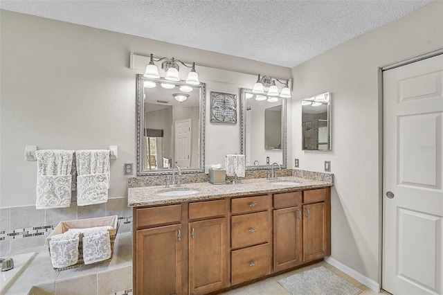 4733 Spring Meadow Ln, Sarasota, FL 34233 - bathroom with double vanity and a textured ceiling