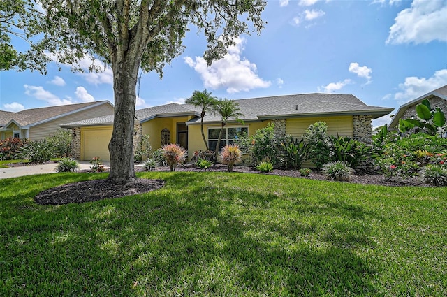 4733 Spring Meadow Ln, Sarasota, FL 34233 - single story home with a garage, a front yard, stucco siding, and concrete driveway