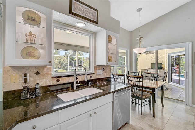 4733 Spring Meadow Ln, Sarasota, FL 34233 - kitchen featuring dishwasher, white cabinetry, tasteful backsplash, hanging light fixtures, and dark stone counters