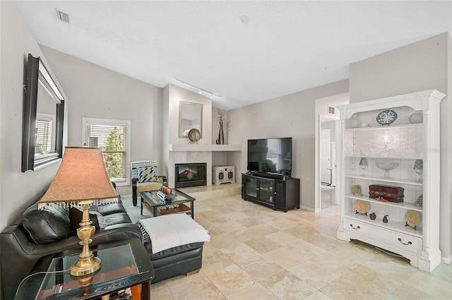 4733 Spring Meadow Ln, Sarasota, FL 34233 - living area featuring vaulted ceiling and a tiled fireplace
