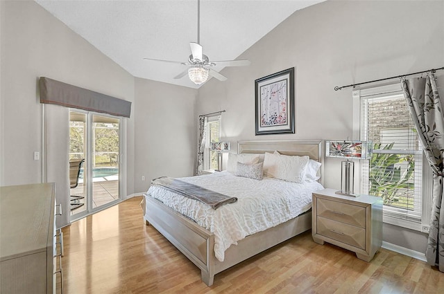 4733 Spring Meadow Ln, Sarasota, FL 34233 - bedroom featuring access to outside, light wood-type flooring, multiple windows, and high vaulted ceiling