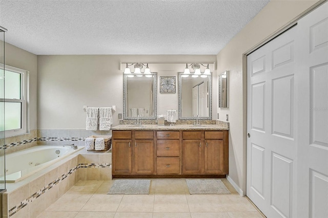 4733 Spring Meadow Ln, Sarasota, FL 34233 - bathroom featuring double vanity, a whirlpool tub, a textured ceiling, and tile patterned flooring