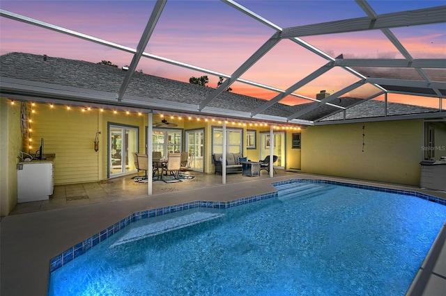 4733 Spring Meadow Ln, Sarasota, FL 34233 - pool at dusk featuring an outdoor pool, a patio area, and a lanai