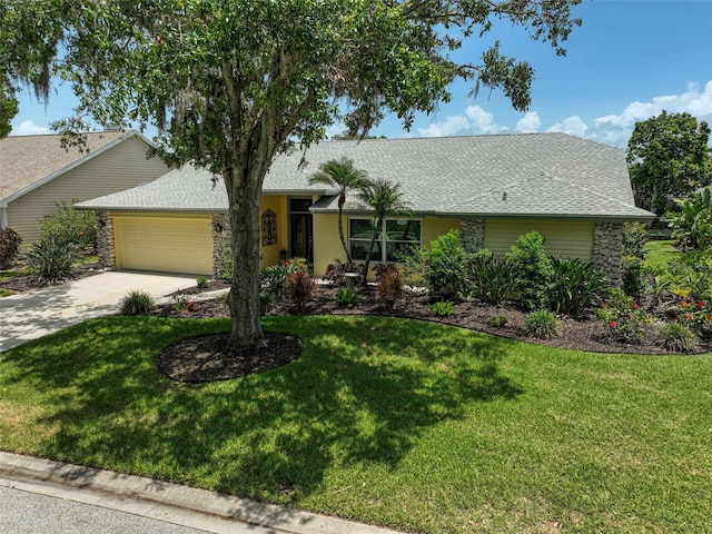 4733 Spring Meadow Ln, Sarasota, FL 34233 - ranch-style house featuring an attached garage, concrete driveway, and a front lawn