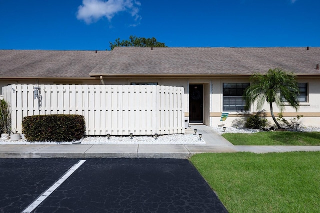 2904 64th St W Unit 2904, Bradenton, FL 34209 - entrance to property featuring a shingled roof, uncovered parking, and stucco siding