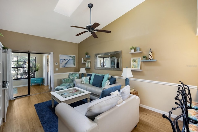 2904 64th St W Unit 2904, Bradenton, FL 34209 - living room with wood finished floors, high vaulted ceiling, ceiling fan, and a skylight