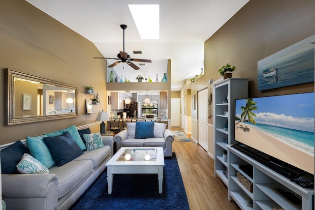 2904 64th St W Unit 2904, Bradenton, FL 34209 - living room with light wood-type flooring, a ceiling fan, high vaulted ceiling, and a skylight