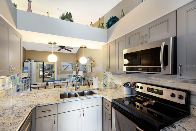 2904 64th St W Unit 2904, Bradenton, FL 34209 - kitchen featuring appliances with stainless steel finishes, gray cabinetry, and tasteful backsplash