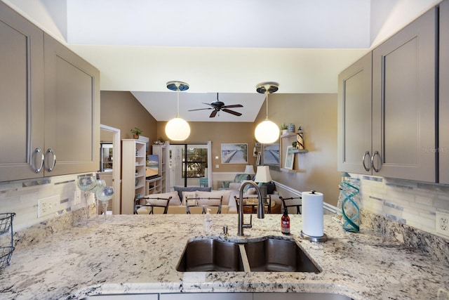 2904 64th St W Unit 2904, Bradenton, FL 34209 - kitchen with a ceiling fan, decorative backsplash, gray cabinetry, light stone counters, and pendant lighting