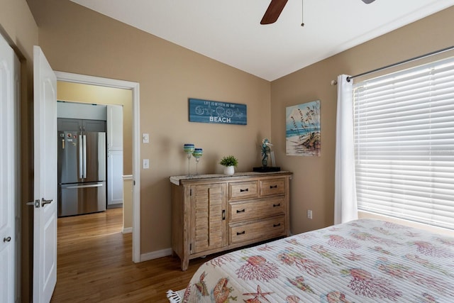 2904 64th St W Unit 2904, Bradenton, FL 34209 - bedroom with freestanding refrigerator, wood finished floors, vaulted ceiling, and a ceiling fan