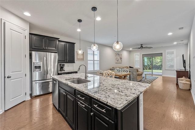 11434 Spring Gate Trl, Bradenton, FL 34211 - kitchen with appliances with stainless steel finishes, dark cabinetry, open floor plan, a ceiling fan, and recessed lighting