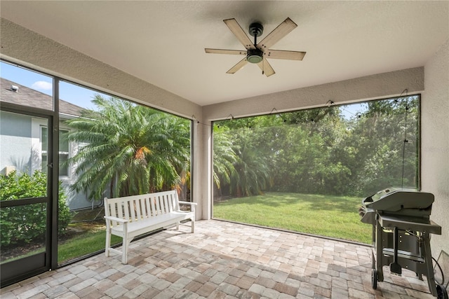11434 Spring Gate Trl, Bradenton, FL 34211 - unfurnished sunroom featuring a textured wall, a ceiling fan, and stone finish floors