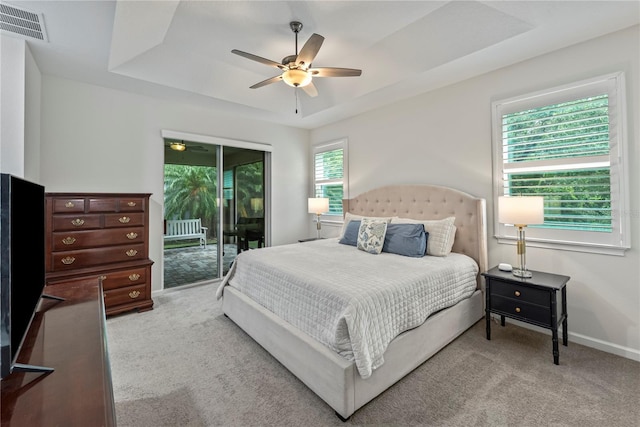 11434 Spring Gate Trl, Bradenton, FL 34211 - bedroom with access to exterior, carpet, a tray ceiling, and ceiling fan