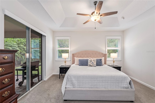 11434 Spring Gate Trl, Bradenton, FL 34211 - bedroom with a tray ceiling, light carpet, and multiple windows