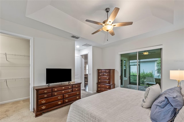 11434 Spring Gate Trl, Bradenton, FL 34211 - bedroom with a raised ceiling, light colored carpet, a walk in closet, a closet, and ceiling fan