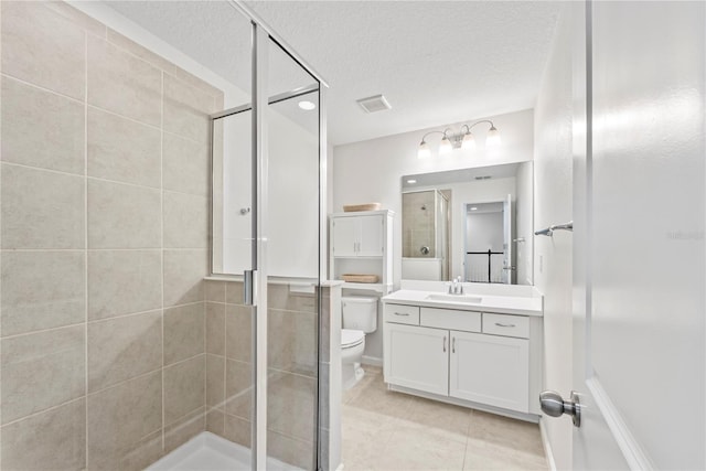 11434 Spring Gate Trl, Bradenton, FL 34211 - full bathroom featuring vanity, a stall shower, tile patterned flooring, and a textured ceiling