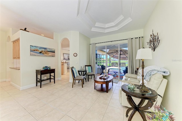 208 147th St NE, Bradenton, FL 34212 - living room featuring arched walkways, light tile patterned flooring, a tray ceiling, and ornamental molding