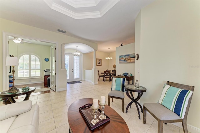 208 147th St NE, Bradenton, FL 34212 - living room featuring a chandelier, arched walkways, crown molding, ornate columns, and light tile patterned floors