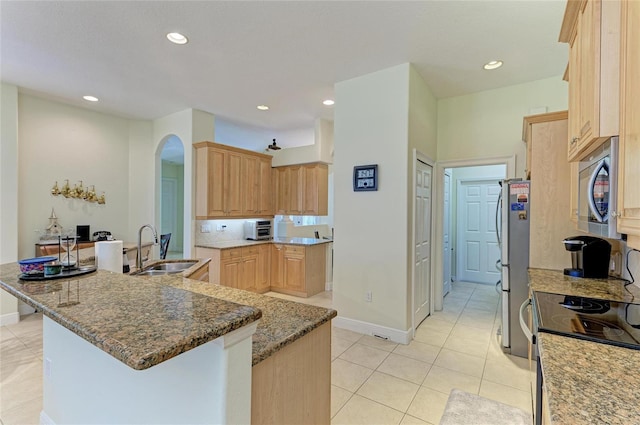 208 147th St NE, Bradenton, FL 34212 - kitchen with appliances with stainless steel finishes, arched walkways, light brown cabinets, recessed lighting, and light tile patterned flooring