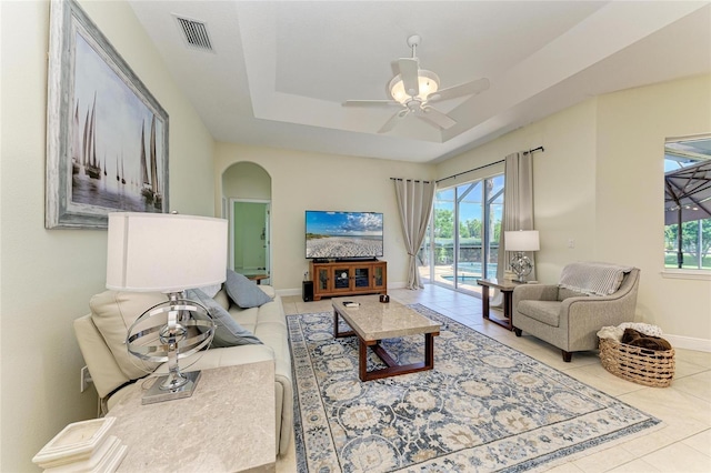 208 147th St NE, Bradenton, FL 34212 - living room featuring plenty of natural light, tile patterned floors, a raised ceiling, and arched walkways
