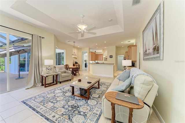 208 147th St NE, Bradenton, FL 34212 - living area featuring a raised ceiling, a ceiling fan, light tile patterned floors, arched walkways, and recessed lighting