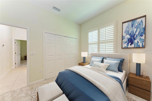 208 147th St NE, Bradenton, FL 34212 - bedroom with a closet, light tile patterned flooring, and light carpet