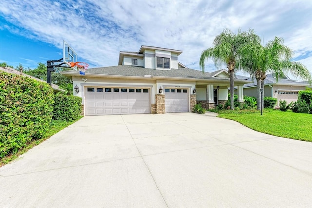 6423 Royal Tern Cir, Lakewood Ranch, FL 34202 - prairie-style home featuring a garage, concrete driveway, a front lawn, a porch, and stone siding