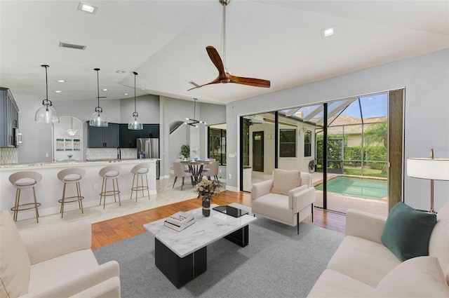 6423 Royal Tern Cir, Lakewood Ranch, FL 34202 - living room featuring a ceiling fan, light wood finished floors, vaulted ceiling, and recessed lighting