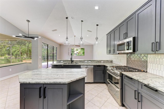6423 Royal Tern Cir, Lakewood Ranch, FL 34202 - kitchen featuring stainless steel appliances, a peninsula, light tile patterned floors, tasteful backsplash, and recessed lighting