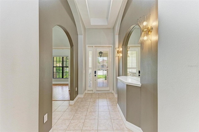 6423 Royal Tern Cir, Lakewood Ranch, FL 34202 - entrance foyer with arched walkways, light tile patterned flooring, and a textured wall