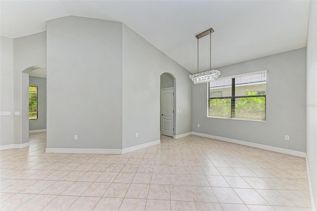 6423 Royal Tern Cir, Lakewood Ranch, FL 34202 - empty room with arched walkways, a chandelier, light tile patterned floors, and high vaulted ceiling
