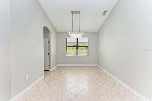 6423 Royal Tern Cir, Lakewood Ranch, FL 34202 - empty room featuring a chandelier, arched walkways, and light tile patterned flooring