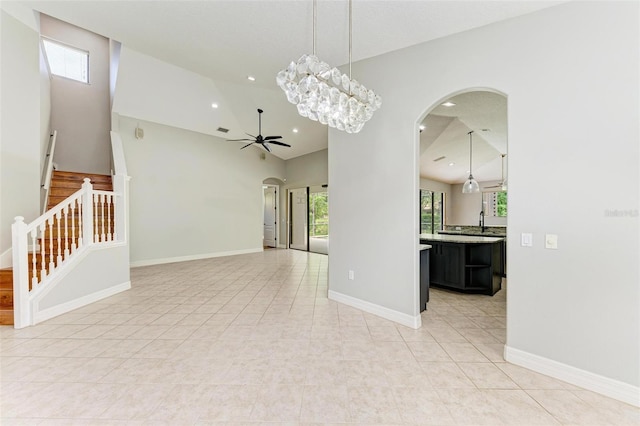 6423 Royal Tern Cir, Lakewood Ranch, FL 34202 - spare room with arched walkways, a ceiling fan, high vaulted ceiling, stairway, and recessed lighting