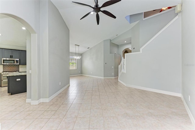 6423 Royal Tern Cir, Lakewood Ranch, FL 34202 - unfurnished living room with arched walkways, high vaulted ceiling, ceiling fan, light tile patterned flooring, and recessed lighting