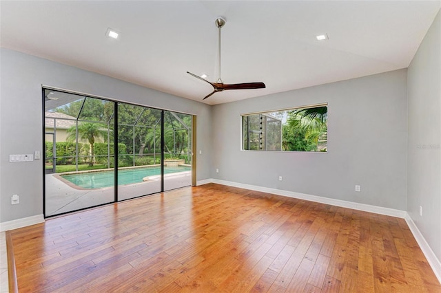 6423 Royal Tern Cir, Lakewood Ranch, FL 34202 - unfurnished room featuring a ceiling fan, plenty of natural light, and wood-type flooring