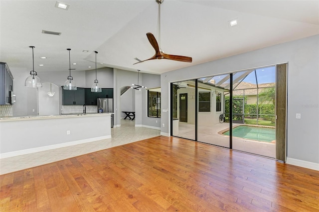 6423 Royal Tern Cir, Lakewood Ranch, FL 34202 - unfurnished living room with ceiling fan, vaulted ceiling, light wood-style floors, and recessed lighting
