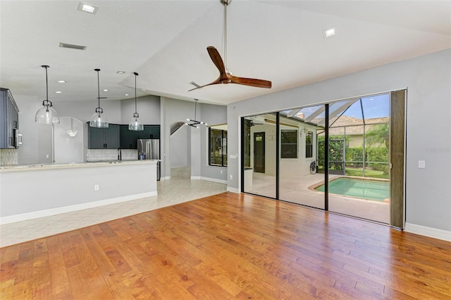 6423 Royal Tern Cir, Lakewood Ranch, FL 34202 - unfurnished living room featuring lofted ceiling, ceiling fan, light wood-type flooring, and recessed lighting