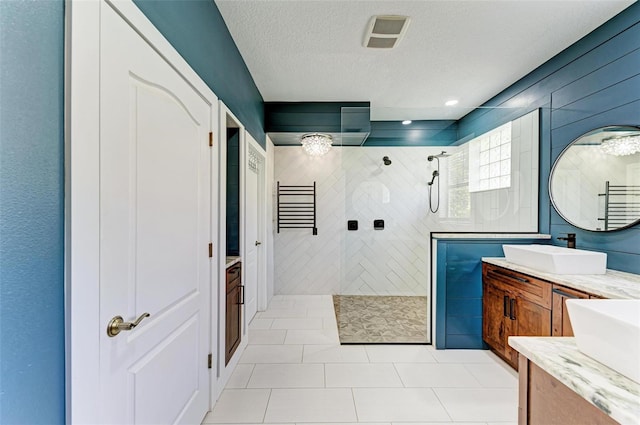 6423 Royal Tern Cir, Lakewood Ranch, FL 34202 - bathroom with vanity, walk in shower, tile patterned flooring, and a textured ceiling