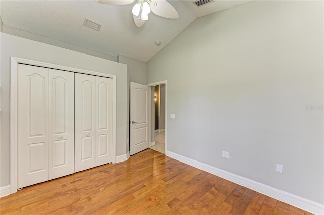 6423 Royal Tern Cir, Lakewood Ranch, FL 34202 - unfurnished bedroom with light wood-style flooring, lofted ceiling, a closet, and ceiling fan