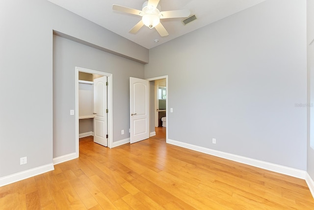 6423 Royal Tern Cir, Lakewood Ranch, FL 34202 - unfurnished bedroom featuring light wood-type flooring, a walk in closet, a closet, a ceiling fan, and lofted ceiling