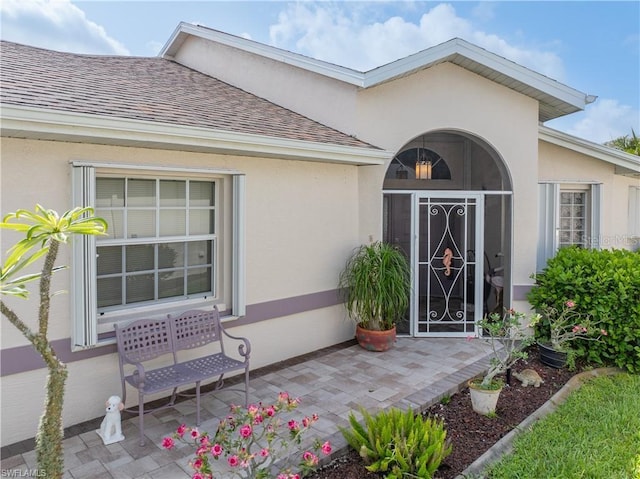 3760 Gloxinia Dr, North Fort Myers, FL 33917 - doorway to property featuring a shingled roof and stucco siding