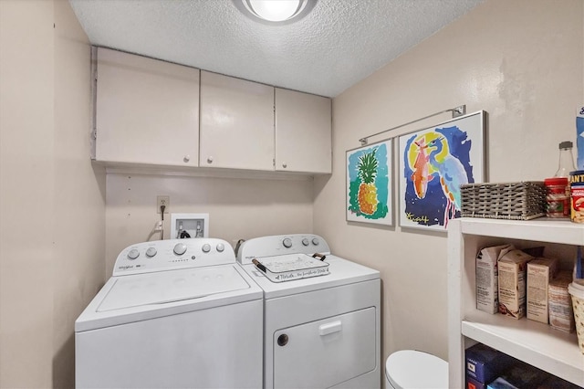 6832 Woodwind Dr Unit 53, Sarasota, FL 34231 - laundry area with washer and clothes dryer, a textured ceiling, and cabinet space
