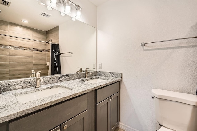 718 17th St E, Bradenton, FL 34208 - bathroom featuring double vanity and a tile shower