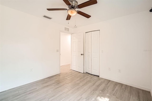 718 17th St E, Bradenton, FL 34208 - unfurnished bedroom with light wood-style floors, a closet, and ceiling fan